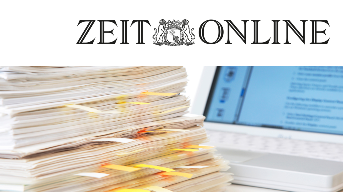 Oben rechts sieht man das Logo von Zeitonline. Darunter ist ein Bild von einem Stapel mit Unterlagen und dahinter steht ein Laptop.